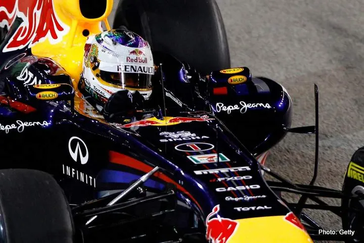SINGAPORE - SEPTEMBER 25: Sebastian Vettel of Germany and Red Bull Racing drives on his way to winning the Singapore Formula One Grand Prix at the Marina Bay Street Circuit on September 25, 2011 in Singapore. (Photo by Paul Gilham/Getty Images) *** Local Caption *** Sebastian Vettel