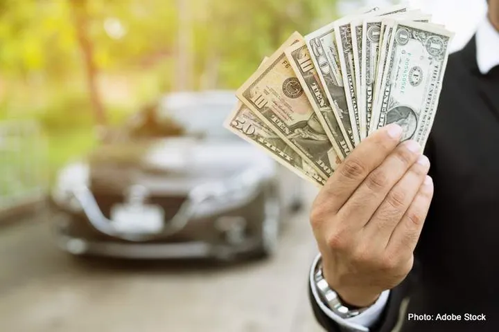 Business man holding money in hand stand front car prepare pay b