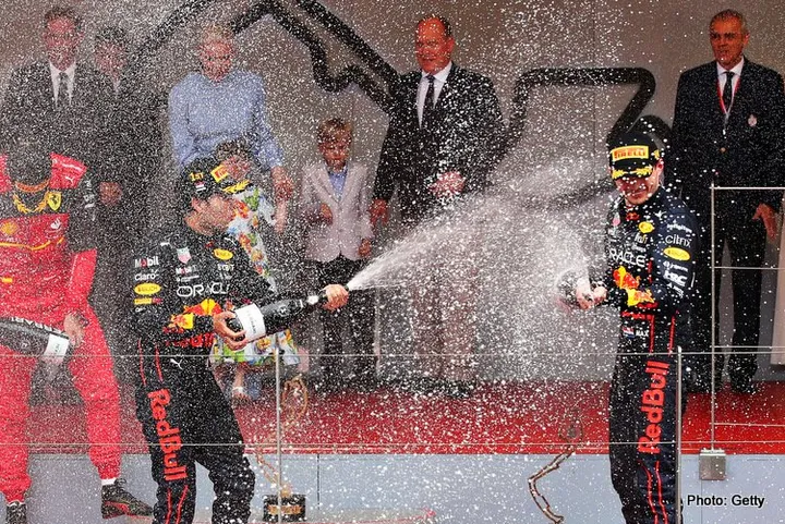MONTE-CARLO, MONACO - MAY 29: Race winner Sergio Perez of Mexico and Oracle Red Bull Racing, Second placed Carlos Sainz of Spain and Ferrari and Third placed Max Verstappen of the Netherlands and Oracle Red Bull Racing celebrate on the podium during the F1 Grand Prix of Monaco at Circuit de Monaco on May 29, 2022 in Monte-Carlo, Monaco. (Photo by Eric Alonso/Getty Images)