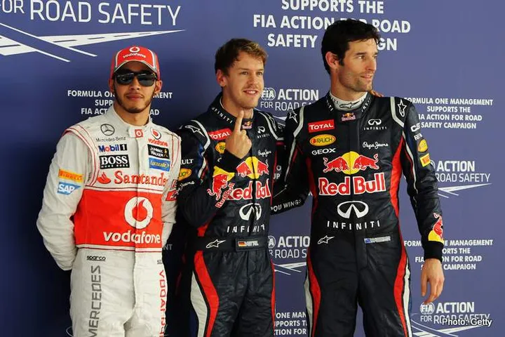 NOIDA, INDIA - OCTOBER 27:  Pole sitter Sebastian Vettel (C) of Germany and Red Bull Racing celebrates in parc ferme with second placed Mark Webber (R) of Australia and Red Bull Racing and third placed Lewis Hamilton (L) of Great Britain and McLaren following qualifying for the Indian Formula One Grand Prix at Buddh International Circuit on October 27, 2012 in Noida, India.  (Photo by Ker Robertson/Getty Images) *** Local Caption *** Sebastian Vettel; Mark Webber; Lewis Hamilton