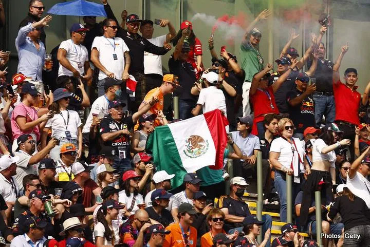 MEXICO CITY, MEXICO - OCTOBER 29: Sergio Perez of Mexico and Oracle Red Bull Racing fans show their support during qualifying ahead of the F1 Grand Prix of Mexico at Autodromo Hermanos Rodriguez on October 29, 2022 in Mexico City, Mexico. (Photo by Chris Graythen/Getty Images)