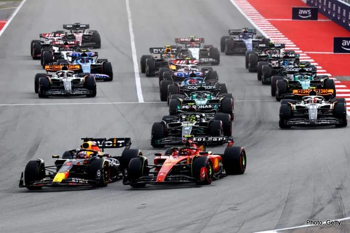 BARCELONA, SPAIN - JUNE 04: Max Verstappen of the Netherlands driving the (1) Oracle Red Bull Racing RB19 leads Carlos Sainz of Spain driving (55) the Ferrari SF-23 and the rest of the field into turn one at the start during the F1 Grand Prix of Spain at Circuit de Barcelona-Catalunya on June 04, 2023 in Barcelona, Spain. (Photo by Mark Thompson/Getty Images)