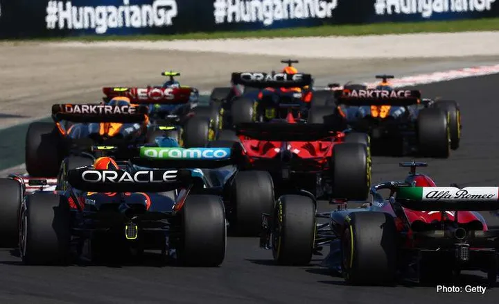 BUDAPEST, HUNGARY - JULY 23: Sergio Perez of Mexico driving the (11) Oracle Red Bull Racing RB19 and Valtteri Bottas of Finland driving the (77) Alfa Romeo F1 C43 Ferrari battle for track position during the F1 Grand Prix of Hungary at Hungaroring on July 23, 2023 in Budapest, Hungary. (Photo by Mark Thompson/Getty Images)