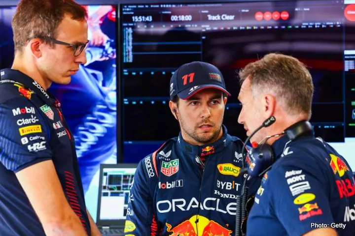 MONZA, ITALY - SEPTEMBER 02: Sergio Perez of Mexico and Oracle Red Bull Racing talks with race engineer Hugh Bird and Red Bull Racing Team Principal Christian Horner in the garage during qualifying ahead of the F1 Grand Prix of Italy at Autodromo Nazionale Monza on September 02, 2023 in Monza, Italy. (Photo by Mark Thompson/Getty Images)