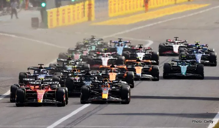 MONZA, ITALY - SEPTEMBER 03: Carlos Sainz of Spain driving (55) the Ferrari SF-23 and Max Verstappen of the Netherlands driving the (1) Oracle Red Bull Racing RB19 lead the field into turn one at the start during the F1 Grand Prix of Italy at Autodromo Nazionale Monza on September 03, 2023 in Monza, Italy. (Photo by Ryan Pierse/Getty Images)