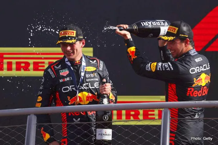 MONZA, ITALY - SEPTEMBER 03: Race winner Max Verstappen of the Netherlands and Oracle Red Bull Racing and Second placed Sergio Perez of Mexico and Oracle Red Bull Racing celebrate on the podium during the F1 Grand Prix of Italy at Autodromo Nazionale Monza on September 03, 2023 in Monza, Italy. (Photo by Ryan Pierse/Getty Images)