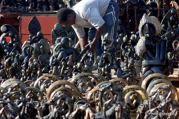 Hawker prepares his stall at African curio crafts market near Hartebeespoort Dam. (Photo: Paul Velasco / PictureNET Africa) travel tourism craft flea market informal business wooden carvings