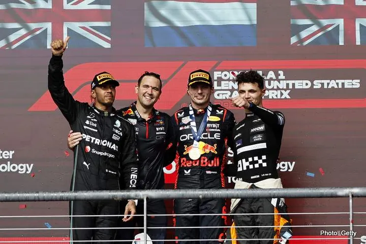AUSTIN, TEXAS - OCTOBER 22: Race winner Max Verstappen of the Netherlands and Oracle Red Bull Racing, Second placed Lewis Hamilton of Great Britain and Mercedes, Third placed Lando Norris of Great Britain and McLaren and John Hammond of Red Bull Racing celebrate on the podium during the F1 Grand Prix of United States at Circuit of The Americas on October 22, 2023 in Austin, Texas. (Photo by Chris Graythen/Getty Images)