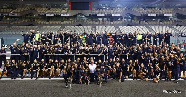 ABU DHABI, UNITED ARAB EMIRATES - NOVEMBER 20: Race Winner Max Verstappen of the Netherlands and Oracle Red Bull Racing and Third placed Sergio Perez of Mexico and Oracle Red Bull Racing celebrate with their team after the F1 Grand Prix of Abu Dhabi at Yas Marina Circuit on November 20, 2022 in Abu Dhabi, United Arab Emirates. (Photo by Mark Thompson/Getty Images)