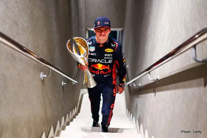 ABU DHABI, UNITED ARAB EMIRATES - NOVEMBER 26: Race winner Max Verstappen of the Netherlands and Oracle Red Bull Racing walks with his trophy in the Paddock after the F1 Grand Prix of Abu Dhabi at Yas Marina Circuit on November 26, 2023 in Abu Dhabi, United Arab Emirates. (Photo by Mark Thompson/Getty Images)