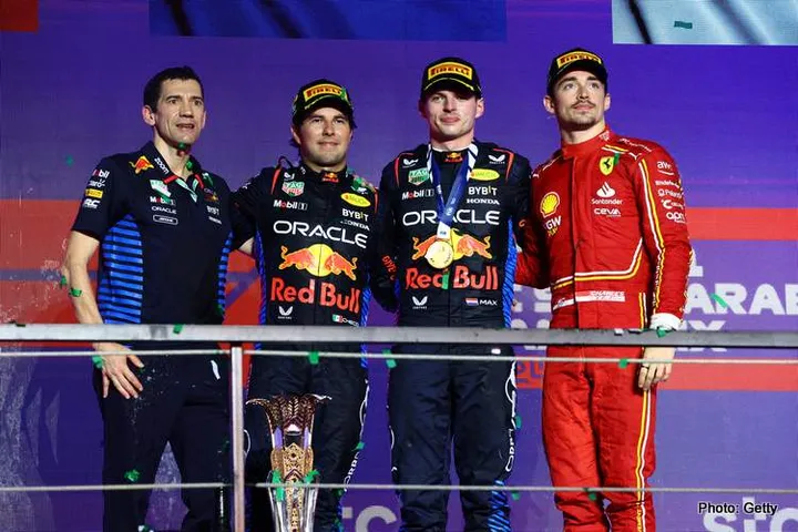JEDDAH, SAUDI ARABIA - MARCH 09: Race winner Max Verstappen of the Netherlands and Oracle Red Bull Racing (second from right), Second placed Sergio Perez of Mexico and Oracle Red Bull Racing (second from left), Third placed Charles Leclerc of Monaco and Ferrari (R) and Jerome Lafarge, Chief Designer at Oracle Red Bull Racing (L) celebrate on the podium during the F1 Grand Prix of Saudi Arabia at Jeddah Corniche Circuit on March 09, 2024 in Jeddah, Saudi Arabia. (Photo by Clive Rose/Getty Images)