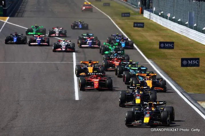 SUZUKA, JAPAN - APRIL 07: Max Verstappen of the Netherlands driving the (1) Oracle Red Bull Racing RB20 leads Sergio Perez of Mexico driving the (11) Oracle Red Bull Racing RB20 and the rest of the field into the first corner at the start of the race during the F1 Grand Prix of Japan at Suzuka International Racing Course on April 07, 2024 in Suzuka, Japan. (Photo by Mark Thompson/Getty Images) // Getty Images / Red Bull Content Pool // SI202404070422 // Usage for editorial use only //