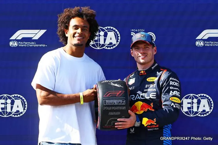IMOLA, ITALY - MAY 18: Pole position qualifier Max Verstappen of the Netherlands and Oracle Red Bull Racing is presented with the Pirelli Pole Position Award by Joshua Zirkzee in parc ferme during qualifying ahead of the F1 Grand Prix of Emilia-Romagna Verstappen's Imola pole winning lap would make Senna proud Autodromo Enzo e Dino Ferrari Circuit on May 18, 2024 in Imola, Italy. (Photo by Mark Thompson/Getty Images)