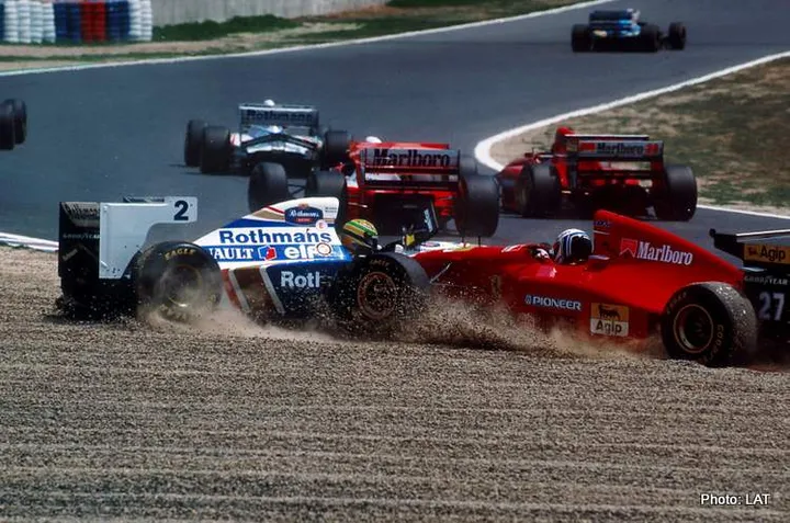 Tanaka International, Aida, Japan, 15-17 April 1994, RD2.Ayrton Senna, Williams FW16-Renault, and Nicola Larini, Ferrari 412T1, end up in the gravel together at the first corner, after Senna had been helped into a spin by Hakkinen which left Larini no where to go.Photo: LAT Photographic/Williams F1. Ref: 1994williams01