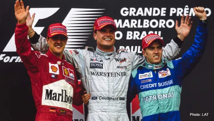 AUTóDROMO JOSé CARLOS PACE, BRAZIL - APRIL 01: David Coulthard, 1st position, Michael Schumacher, 2nd position, and Nick Heidfeld, 3rd position, celebrate on the podium during the Brazilian GP at Autódromo José Carlos Pace on April 01, 2001 in Autódromo José Carlos Pace, Brazil. (Photo by LAT Images)