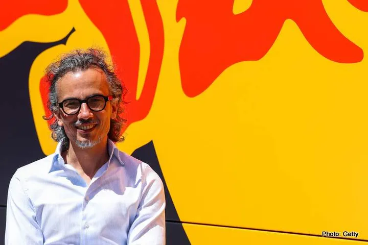 Laurent Mekies stands in front of the famous sun and bull of the Red Bull logo. // Getty Images // SI202507100331 // Usage for editorial use only //