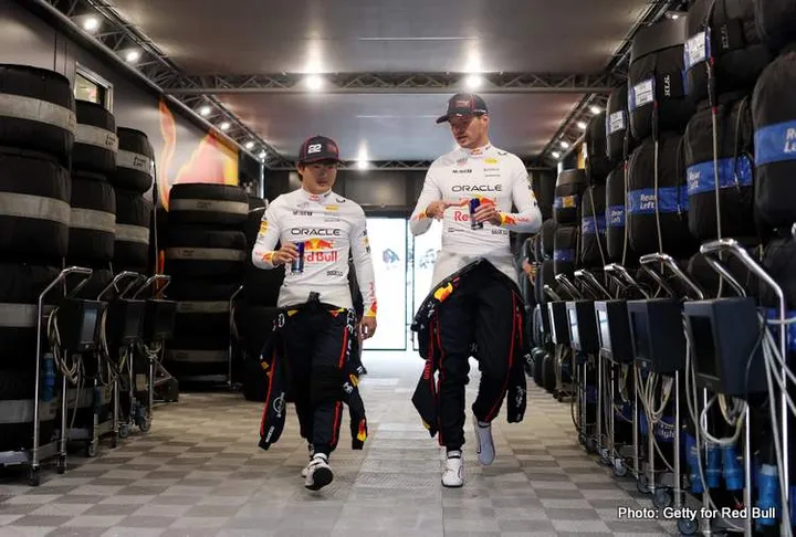 BUDAPEST, HUNGARY - AUGUST 01: Yuki Tsunoda of Japan and Oracle Red Bull Racing talks with Max Verstappen of the Netherlands and Oracle Red Bull Racing in the garage during practice ahead of the F1 Grand Prix of Hungary at Hungaroring on August 01, 2025 in Budapest, Hungary. (Photo by Mark Thompson/Getty Images) // Getty Images / Red Bull Content Pool // SI202508011439 // Usage for editorial use only //