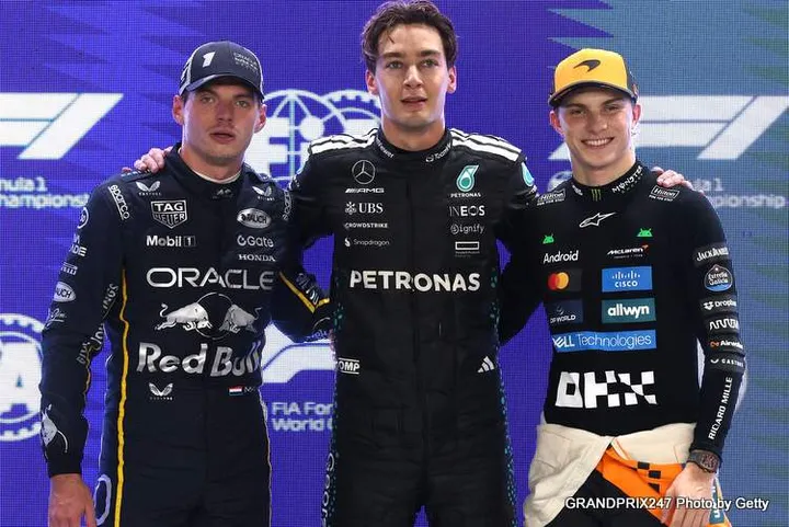 SINGAPORE, SINGAPORE - OCTOBER 04: Pole position qualifier George Russell of Great Britain and Mercedes AMG Petronas F1 Team Second placed qualifier Max Verstappen of the Netherlands and Oracle Red Bull Racing and Third placed qualifier Oscar Piastri of Australia and McLaren look on during qualifying ahead of the F1 Grand Prix of Singapore at Marina Bay Street Circuit on October 04, 2025 in Singapore, Singapore. (Photo by Steven Tee/LAT Images) // Getty Images / Red Bull Content Pool // SI202510040574 // Usage for editorial use only //