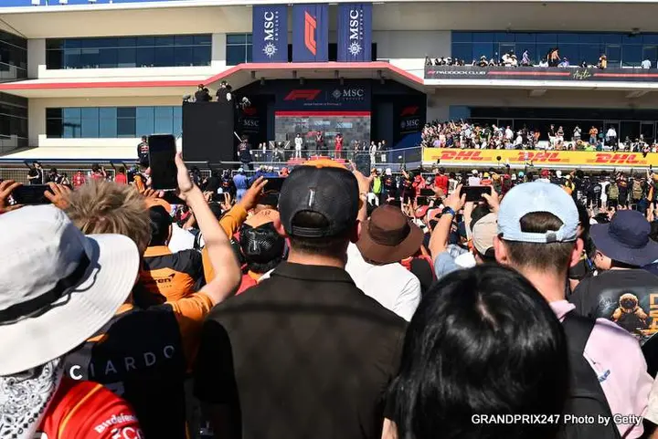 AUSTIN, TEXAS - OCTOBER 19: Race winner Max Verstappen of the Netherlands and Oracle Red Bull Racing Second placed Lando Norris of Great Britain and McLaren Third placed Charles Leclerc of Monaco and Scuderia Ferrari and Chris Gent, Chief Mechanic at Oracle Red Bull Racing on the podium during the F1 Grand Prix of United States at Circuit of The Americas on October 19, 2025 in Austin, Texas. (Photo by Michael Potts/LAT Images) // Getty Images / Red Bull Content Pool // SI202510200014 // Usage for editorial use only //