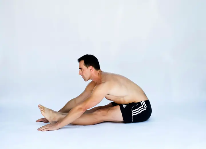 a shirtless man is sitting on the Tips to Enhance Your Reflexes and Reaction Time