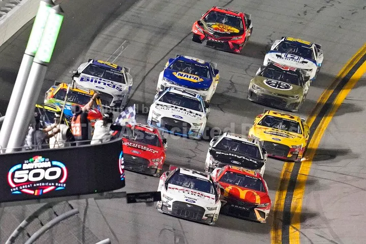 Austin Cindric (2) beats Bubba Wallace (23) to the checkered flag to win the NASCAR Daytona 500 auto race Sunday, Feb. 20, 2022, at Daytona International Speedway in Daytona Beach, Fla. (AP Photo/David Graham)