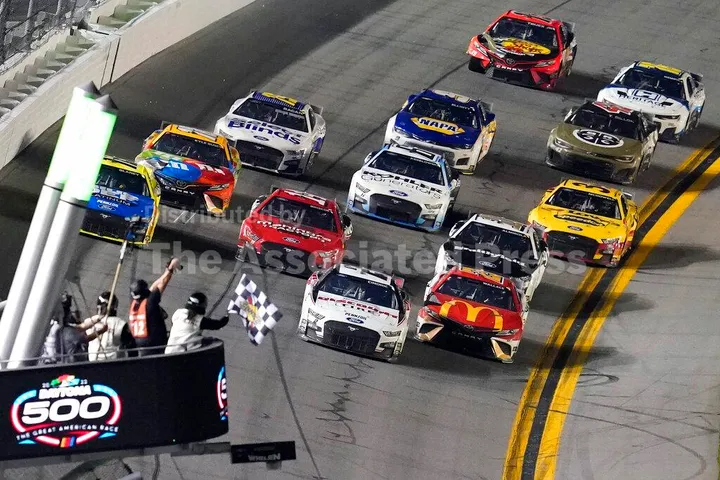Austin Cindric (2) beats Bubba Wallace (23) to the checkered flag to win the NASCAR Daytona 500 auto race Sunday, Feb. 20, 2022, at Daytona International Speedway in Daytona Beach, Fla. (AP Photo/David Graham)