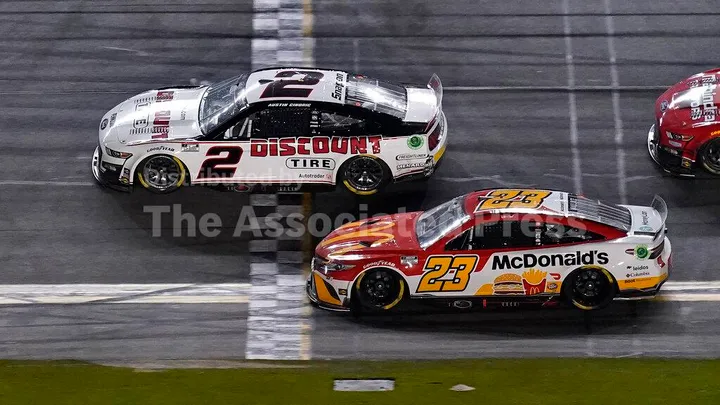 Austin Cindric (2) edges out Bubba Wallace (23) to win the NASCAR Daytona 500 auto race Sunday, Feb. 20, 2022, at Daytona International Speedway in Daytona Beach, Fla. (AP Photo/Chris O'Meara)