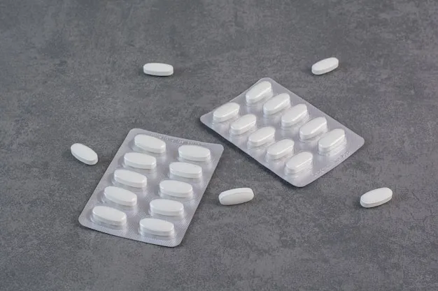 Two packs of white pills on marble table.