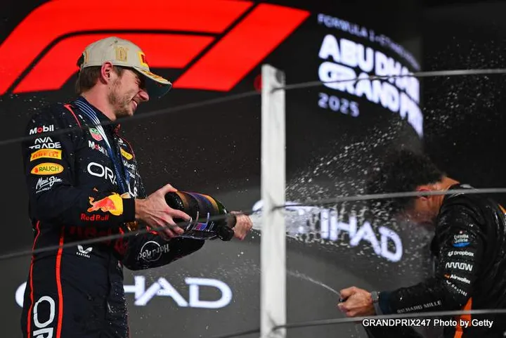 ABU DHABI, UNITED ARAB EMIRATES - DECEMBER 07: Race winner Max Verstappen of the Netherlands and Oracle Red Bull Racing and 2025 F1 World Drivers Champion and Third placed Lando Norris of Great Britain and McLaren celebrate on the podium during the F1 Grand Prix of Abu Dhabi at Yas Marina Circuit on December 07, 2025 in Abu Dhabi, United Arab Emirates. (Photo by Rudy Carezzevoli/Getty Images) // Getty Images / Red Bull Content Pool // SI202512070398 // Usage for editorial use only //