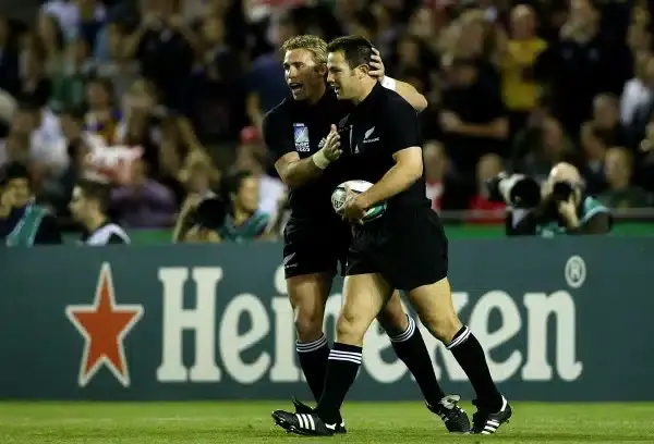 MELBOURNE, AUSTRALIA - NOVEMBER 8: Leon MacDonald of New Zealand is congratulated by team mate Justin Marshall after his try during the Rugby World Cup Quarter Final 1 match between New Zealand and South Africa at the Telstra Dome November 8, 2003 in Melb