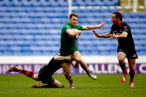 READING, ENGLAND - APRIL 05: Alex Lewington of London Irish is tackled by Tim Visser (L) and Andries Strauss of Edinburgh (R) during the European Rugby Challenge Cup Quarter Final between London Irish and Edinburgh Rugby at the Madejski Stadium on April 5
