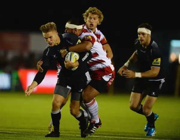 NEWCASTLE UPON TYNE, ENGLAND - OCTOBER 16: Chris Harris (L) of Newcastle Falcons tackled by John Afoa of Gloucester during the Aviva Premiership match between Newcastle Falcons and Gloucester at Kingston Park on October 16, 2015 in Newcastle upon Tyne, En
