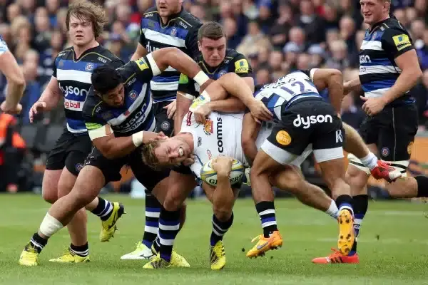 BATH, ENGLAND - OCTOBER 17: Sam Hill of Exeter Chiefs is held by Alafoli Faosiliva, George Ford and Kyle Eastmond of Bath Rugby during the Aviva Premiership match between Bath Rugby and Exeter Chiefs at the Recreation Ground on October 17, 2015 in Bath, E