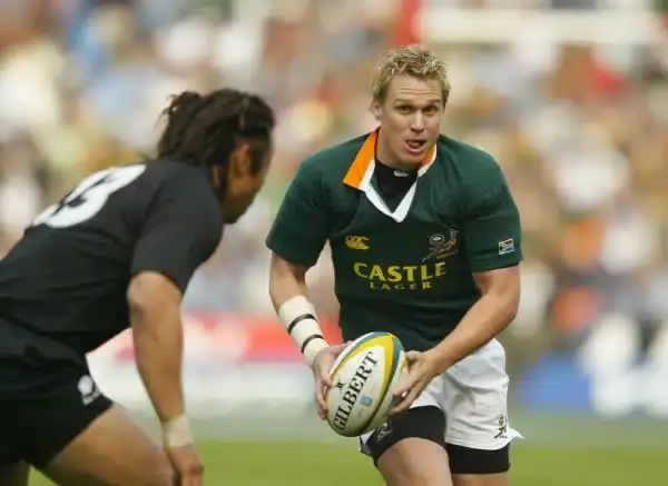 JOHANNESBURG, SOUTH AFRICA - AUGUST 14: Jan De Villiers of South Africa takes on New Zealand's Tana Umaga during the Tri-Nations Rugby Union International between South Africa and New Zealand at Ellis Park on August 14, 2004 in Johannesburg, South Africa.