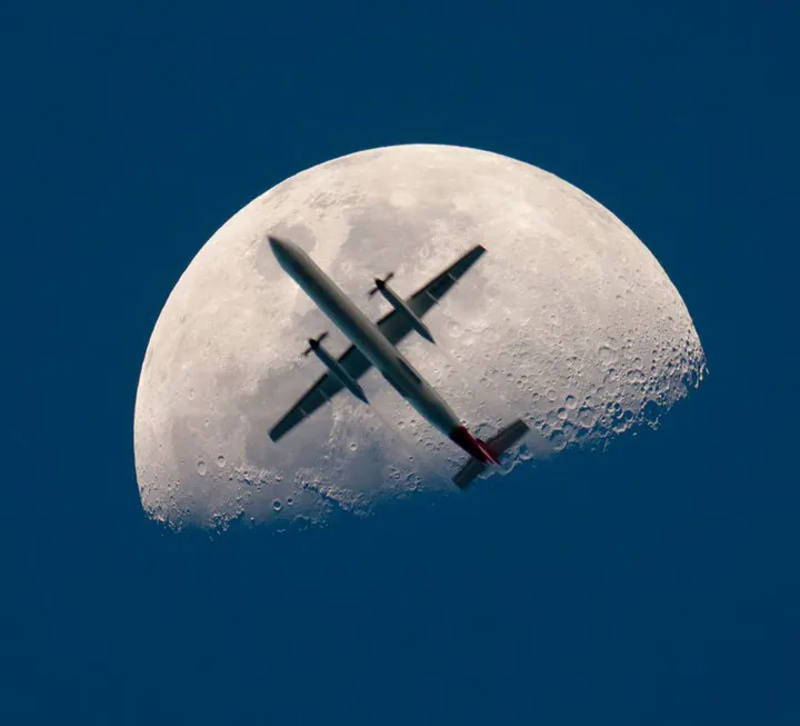 airplane passing the mooon perfect timing