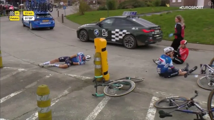 Alaphilippe (left) on the ground in the Omloop